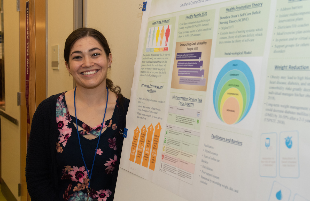 Graduate and her research display