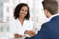 woman shaking hands with a male professional